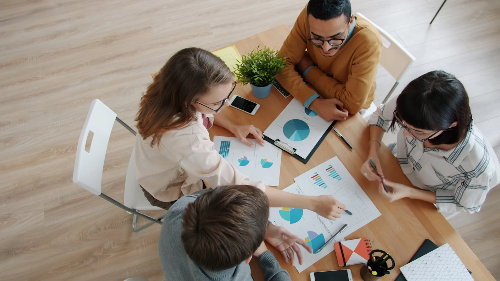 Advertising agency team reviewing campaign performance charts