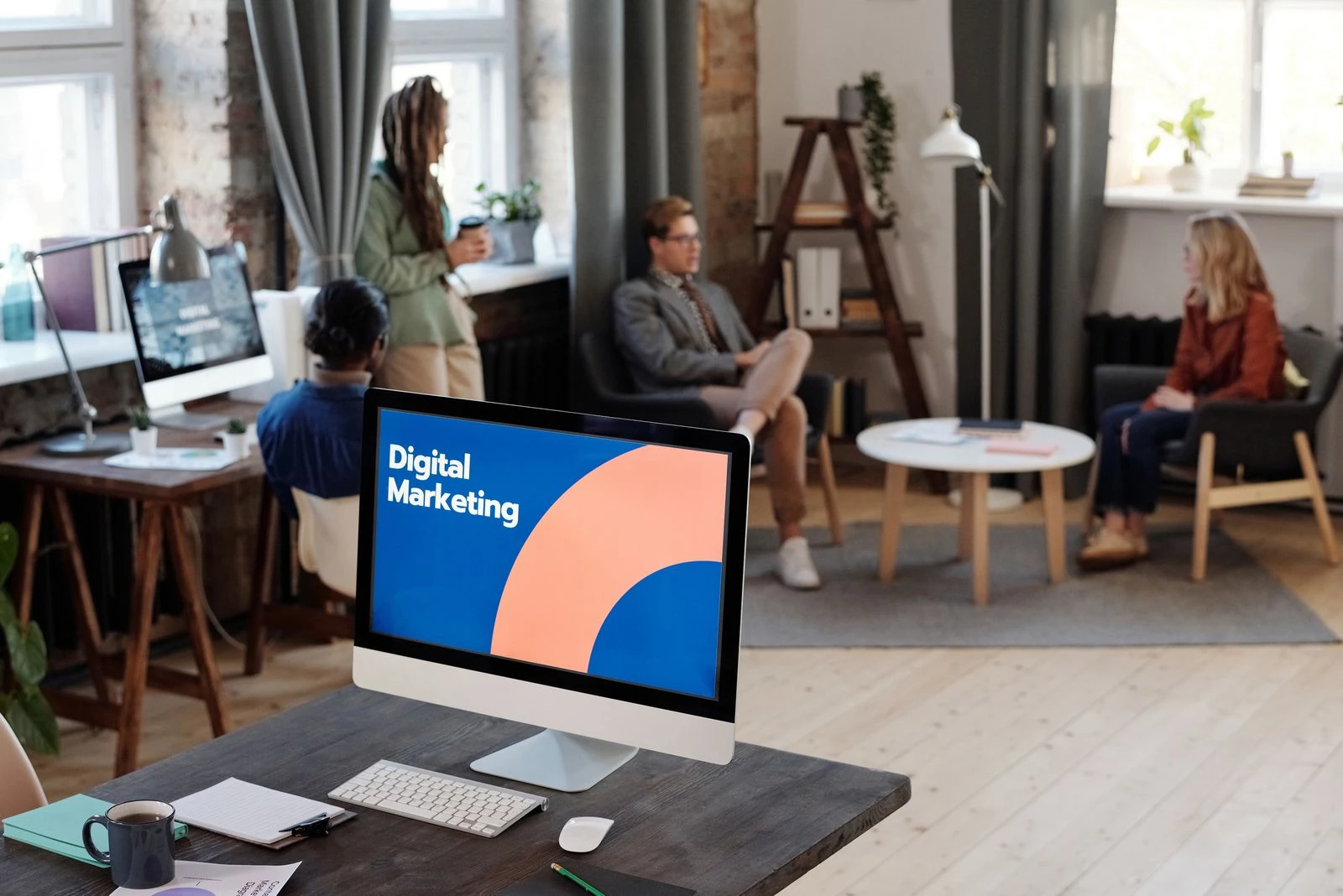 Digital marketing dashboard on desktop screen in shared workspace