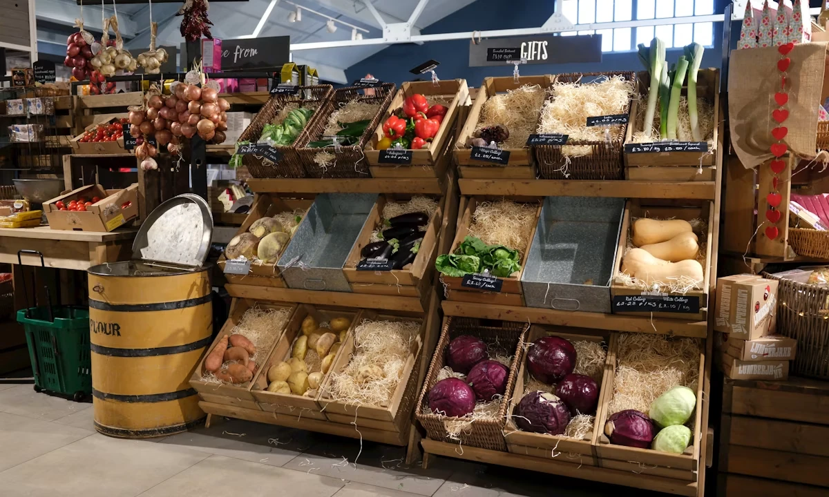 Fresh produce displayed in wooden crates at a farm stand market