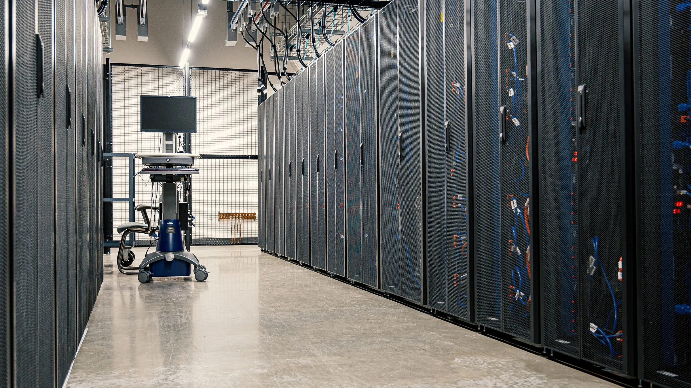Modern data center corridor with illuminated server racks powering AI infrastructure