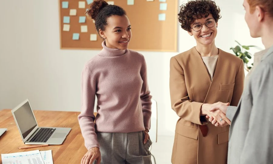 Business colleagues shaking hands after an AI consulting meeting