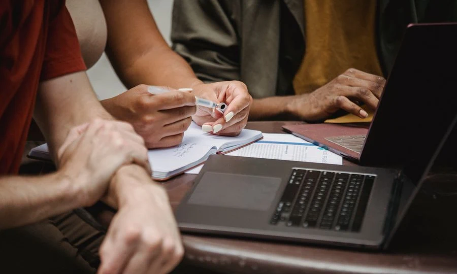 AI startup team collaborating on laptops in office