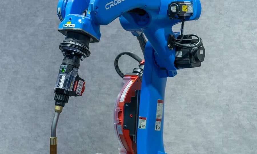 Robotic welding station with a blue industrial automation robot