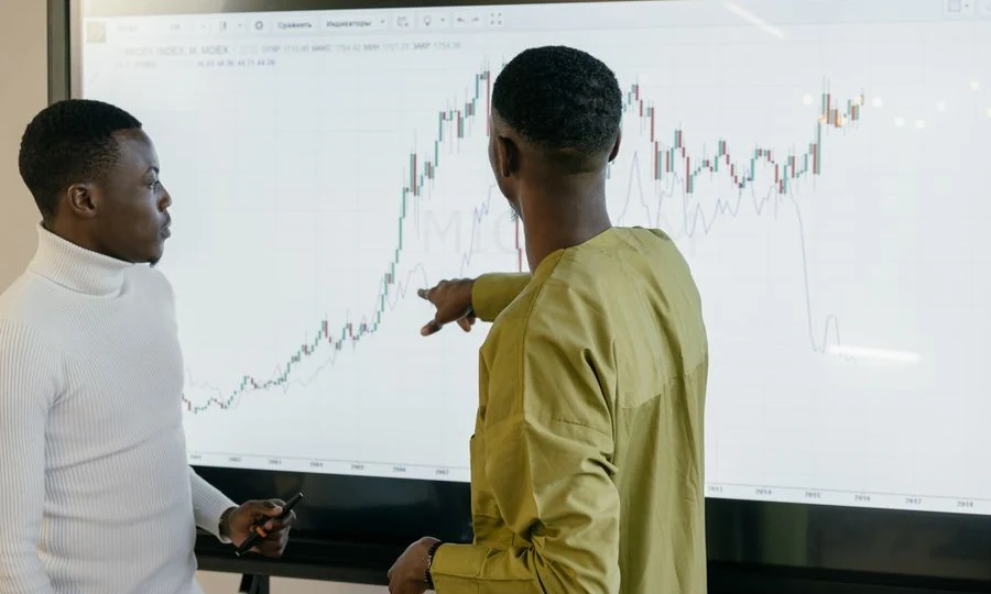 Professionals discussing predictive analytics on a data graph screen