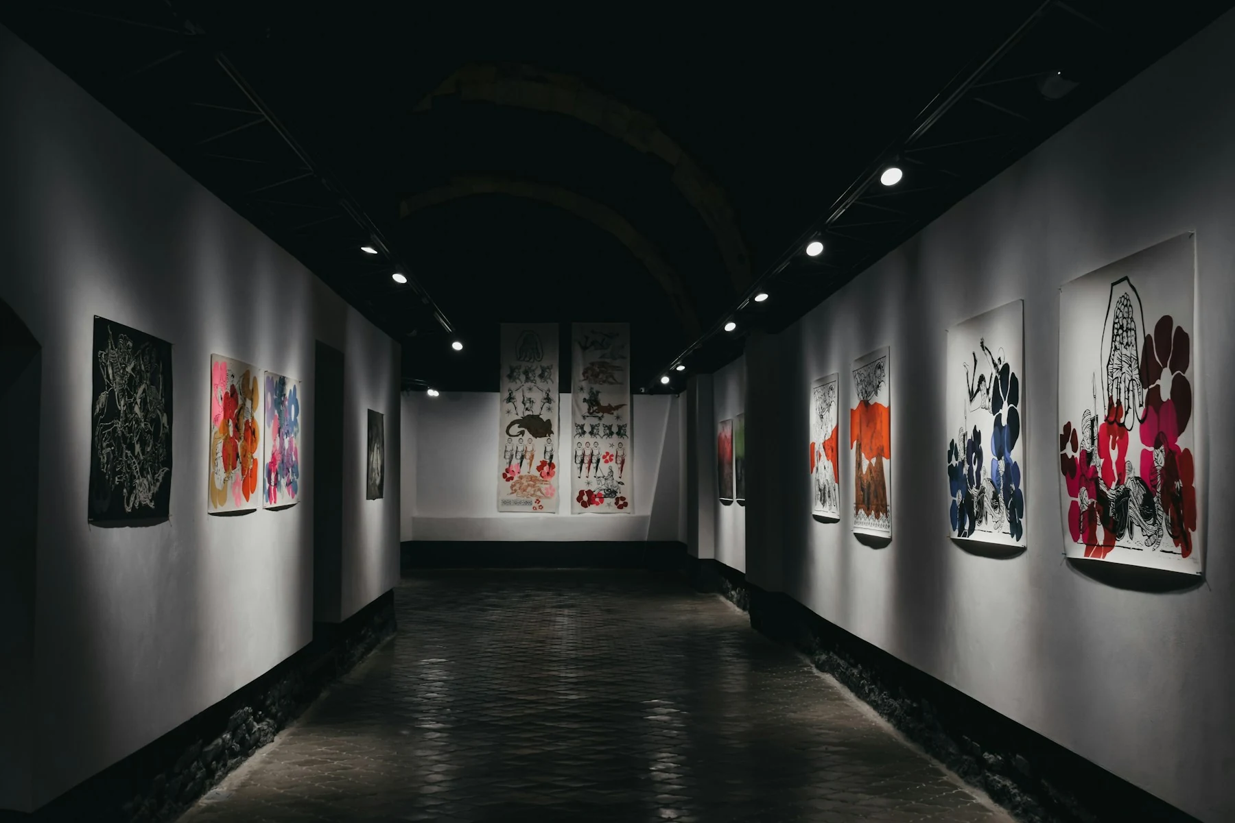 Contemporary art gallery corridor with colorful framed exhibition pieces