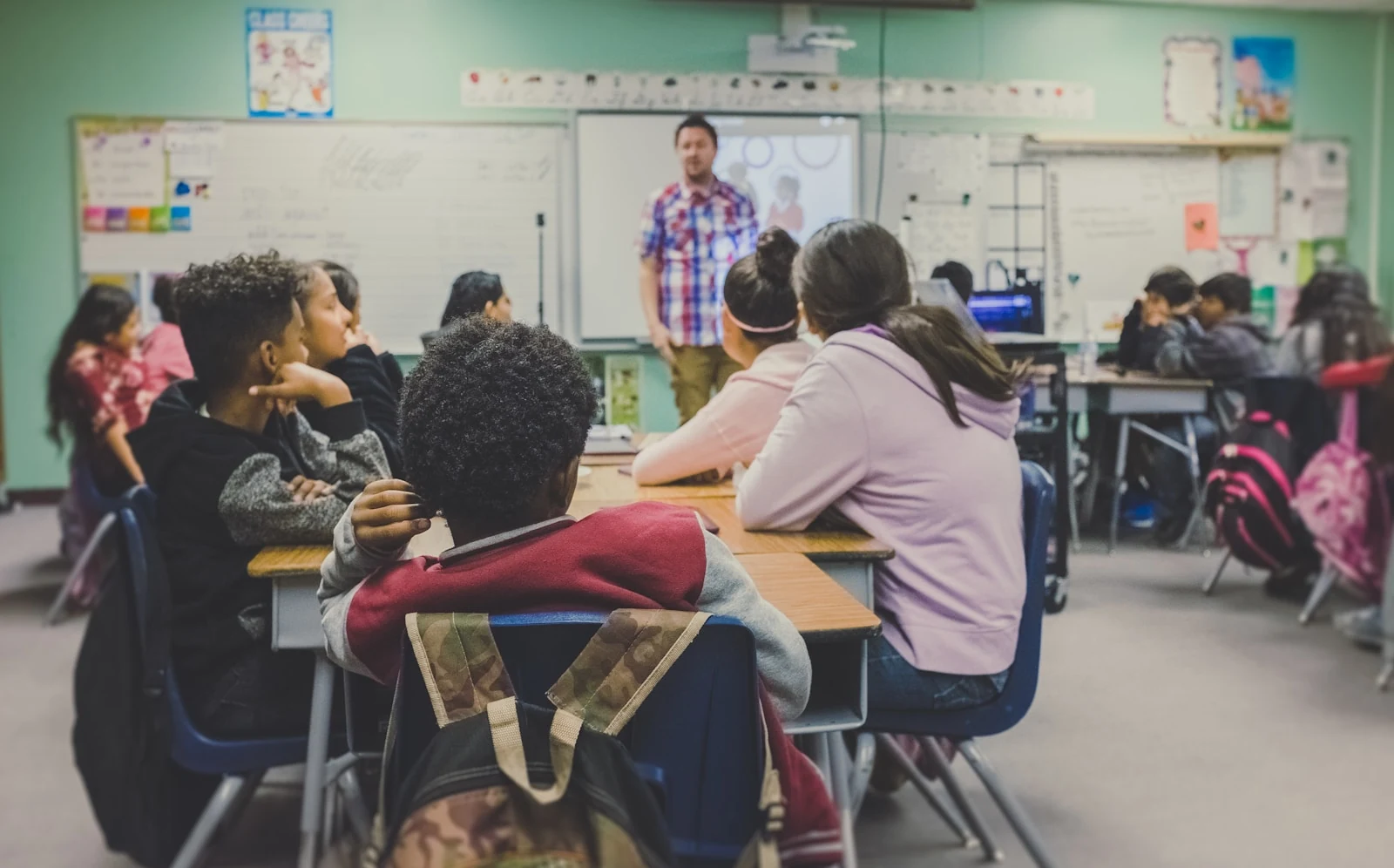 Teacher leading students in a bright classroom learning session