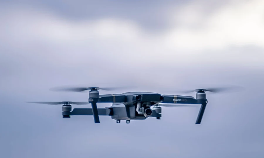 Drone flying in cloudy sky
