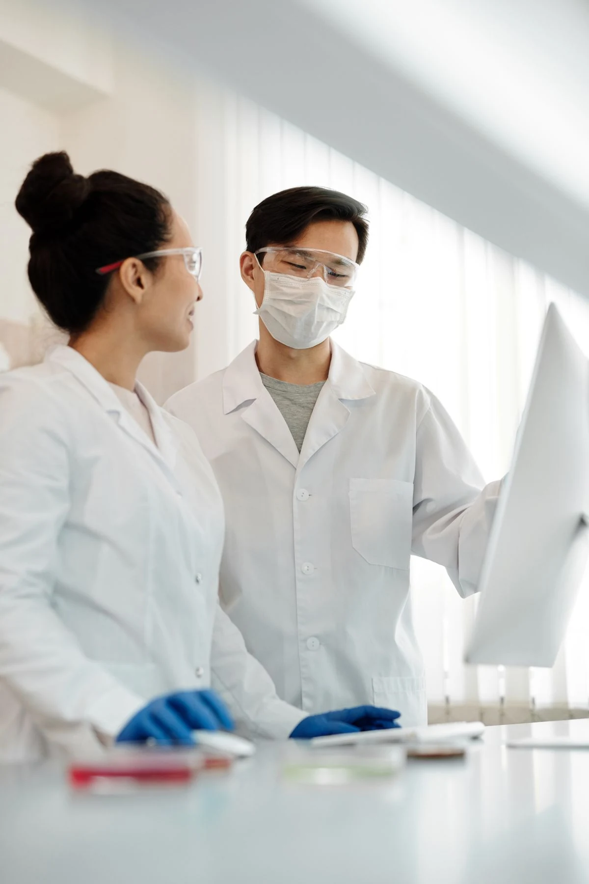 Two scientists reviewing data on a screen in a biotech startup lab