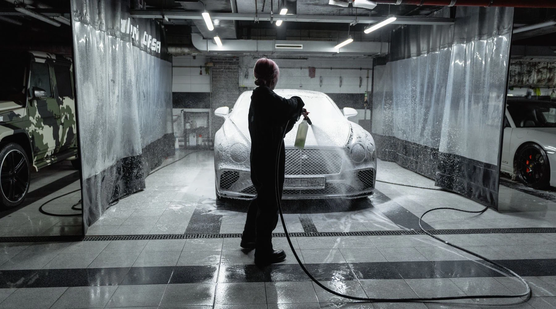 Car being cleaned with foam at a professional car wash