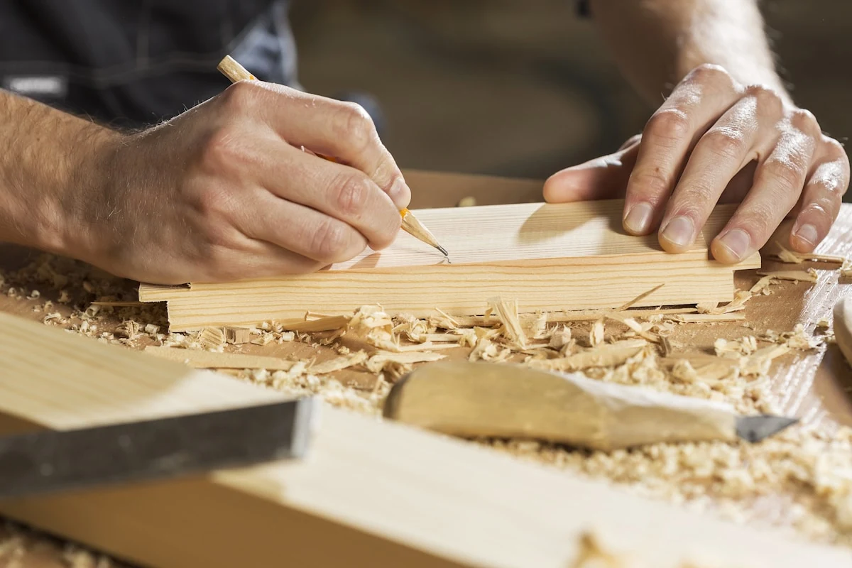 Carpenter cutting lumber for outdoor deck construction