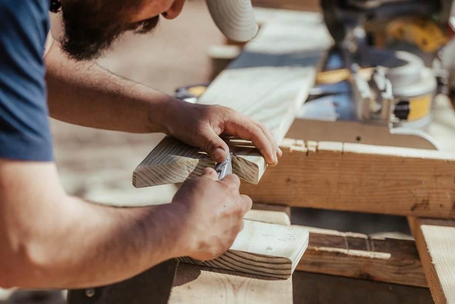 New carpenter marking lumber in a workshop