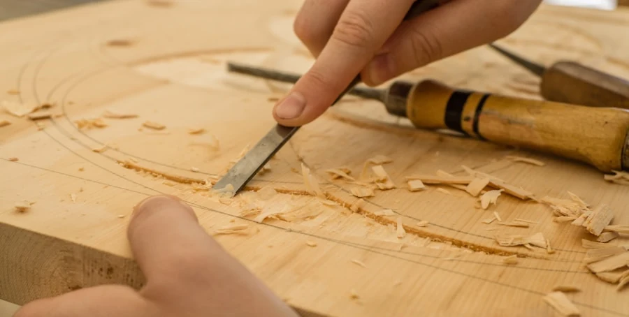Handmade wood product being carved with a chisel