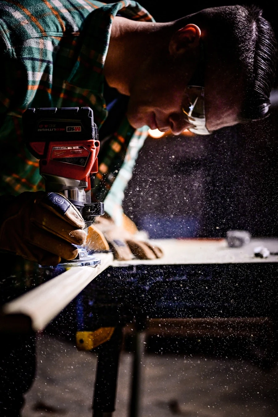 Independent carpenter using a power router in a wood shop