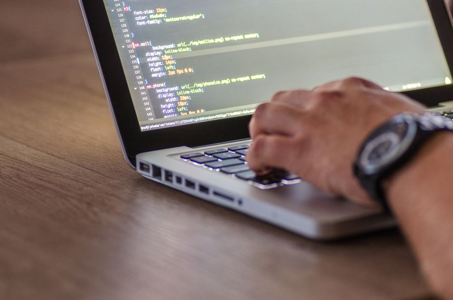 Hands typing on laptop keyboard for secure access