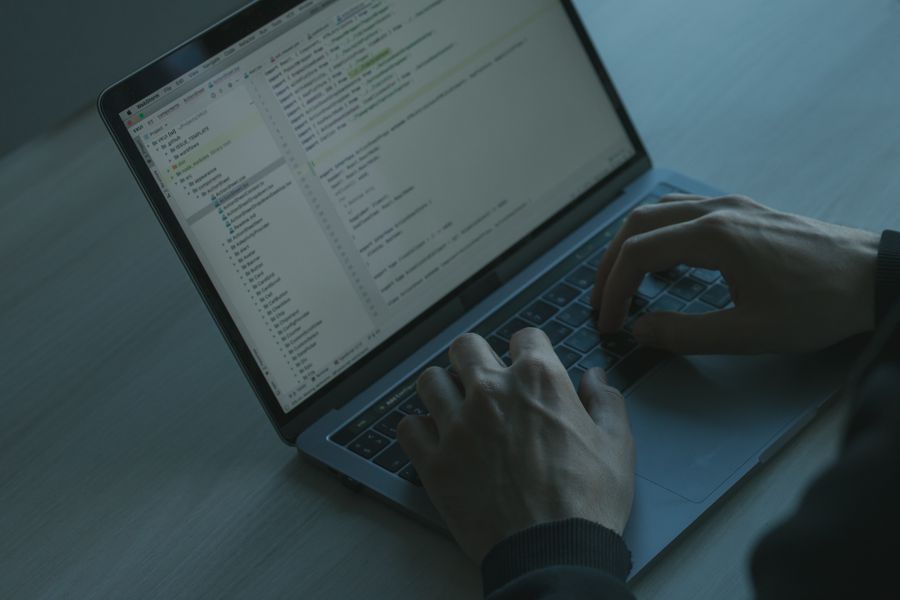 Hands typing on keyboard monitoring security systems