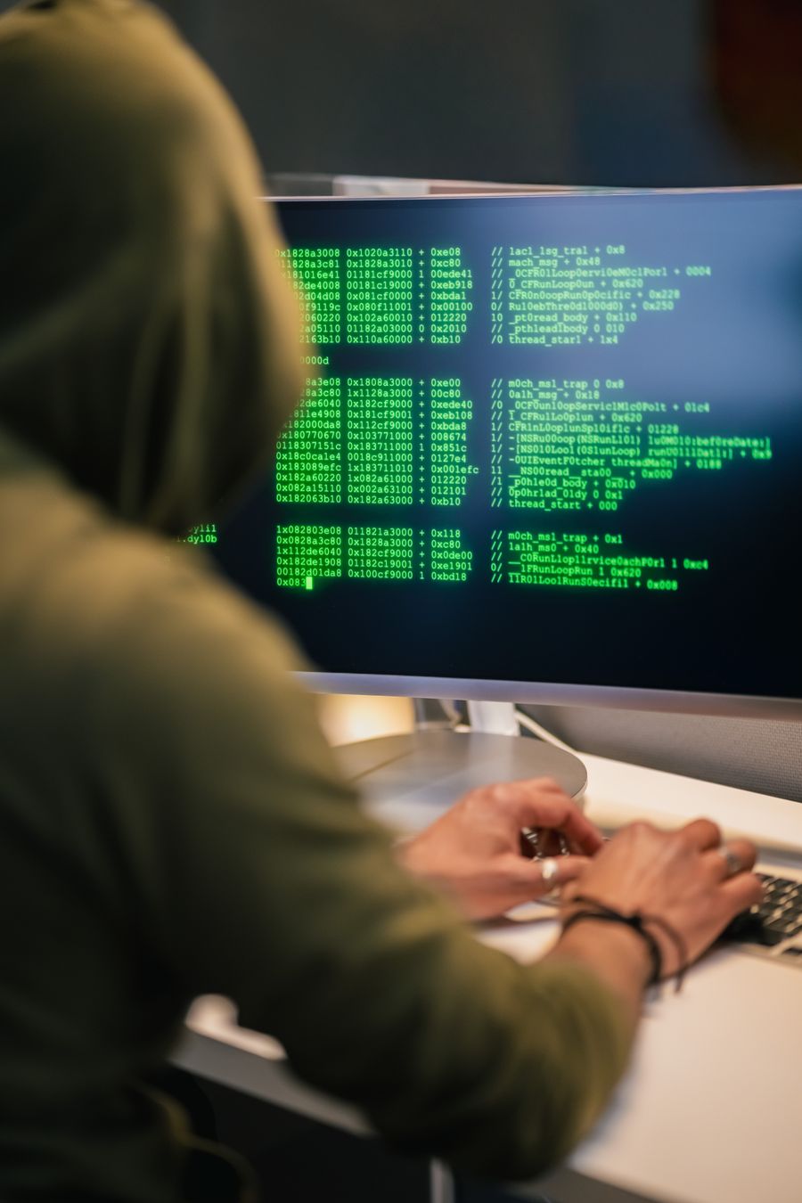 Ethical hacker working on cybersecurity code in hoodie