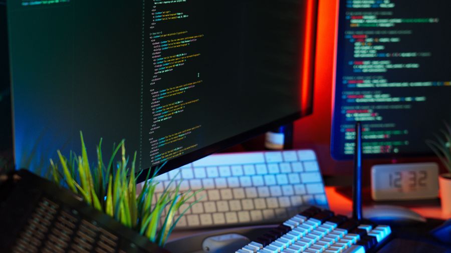 Security operations center monitors displaying live code and logs