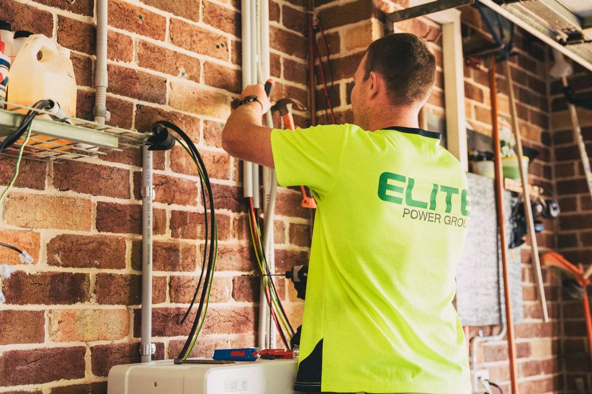 Electrician working on a solar battery storage installation