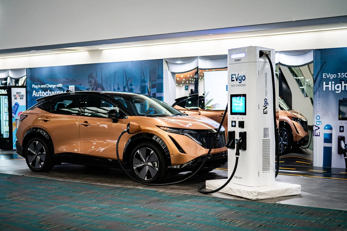 Electric vehicle plugged into a fast charging station