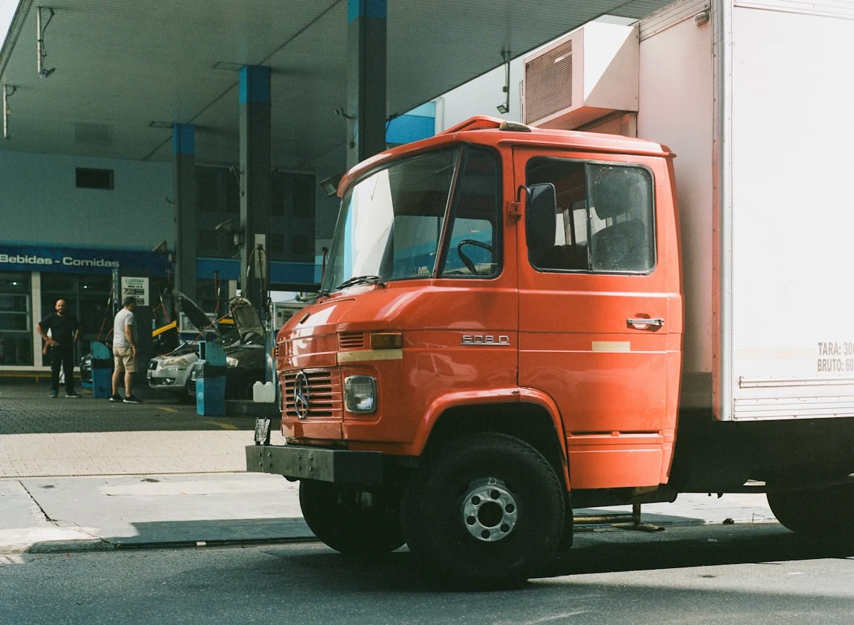 Fuel delivery truck parked at a gas station