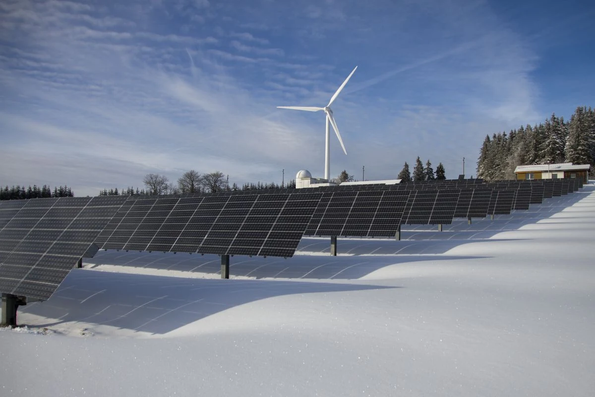 Solar panels and wind turbine in a renewable energy landscape