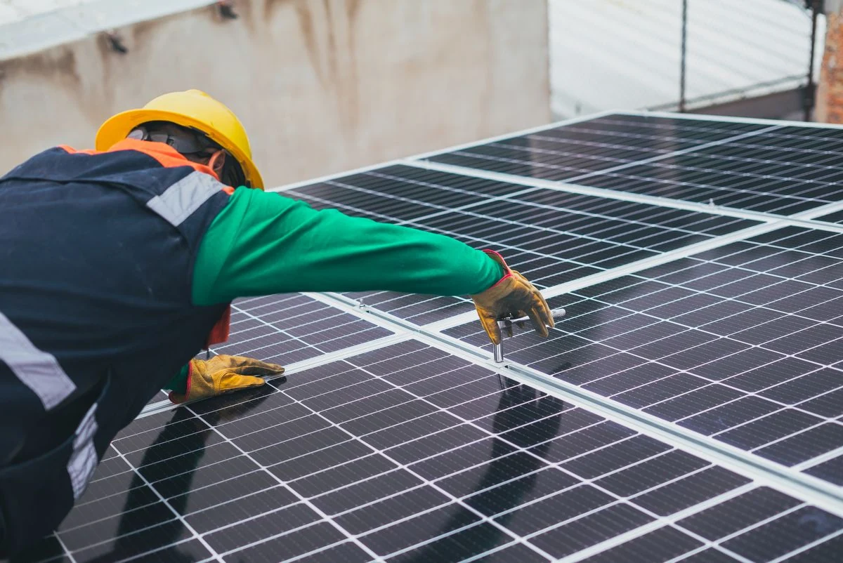 Solar technician installing solar panels
