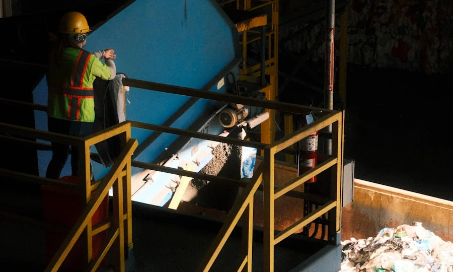 Worker sorting recyclable material at a recycling facility