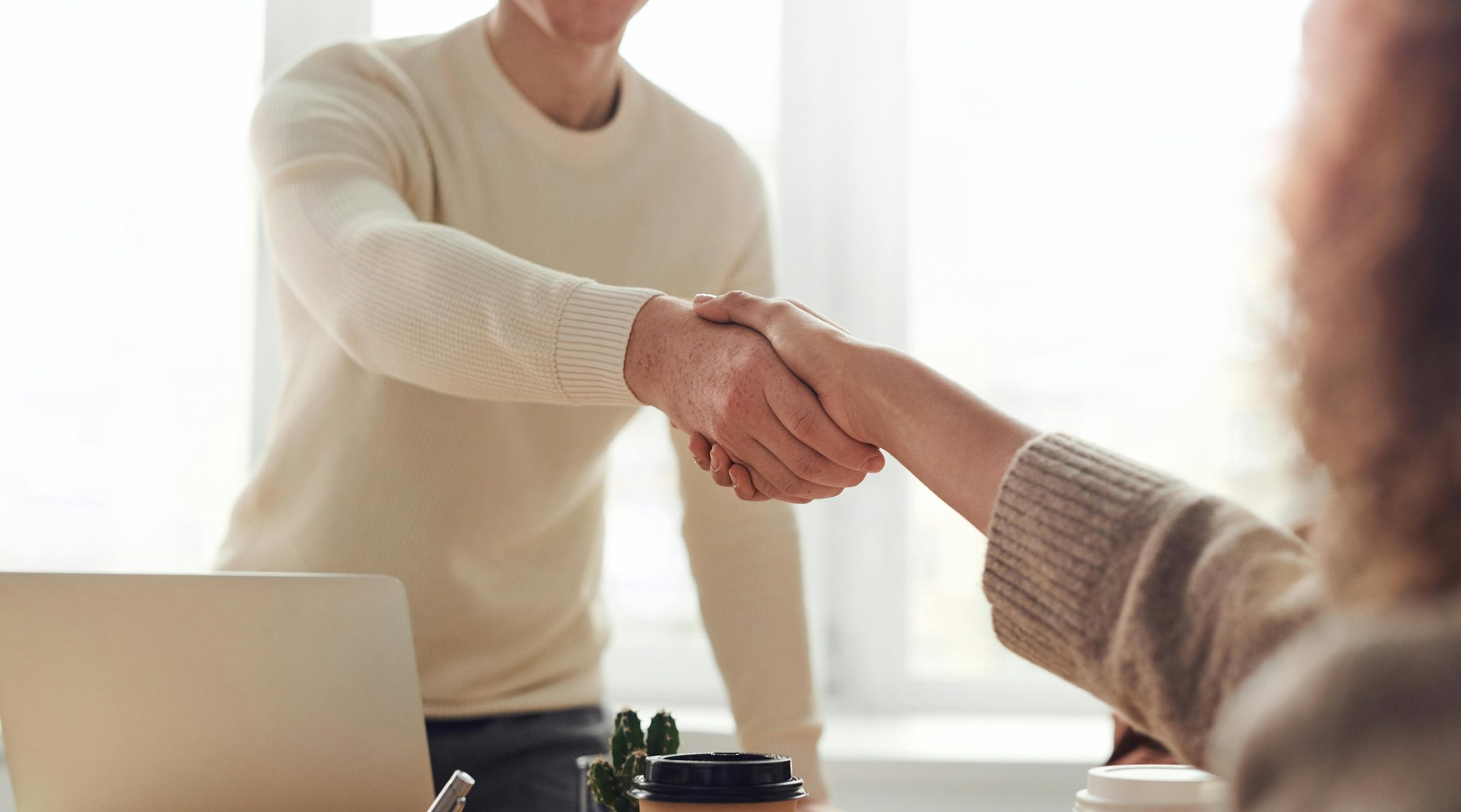 Finance professionals shaking hands after a client-ready brand consultation