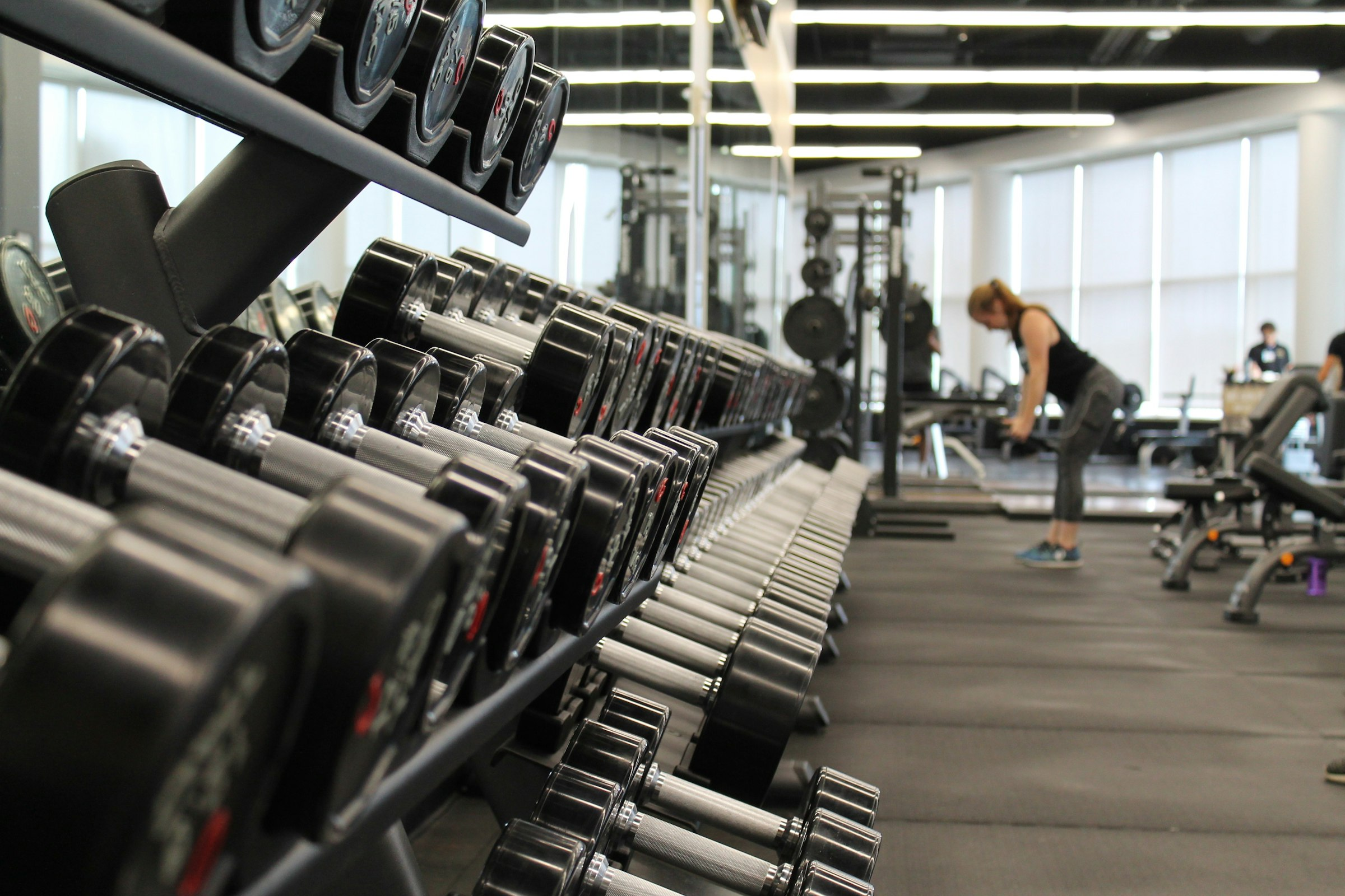 Modern gym interior with members training