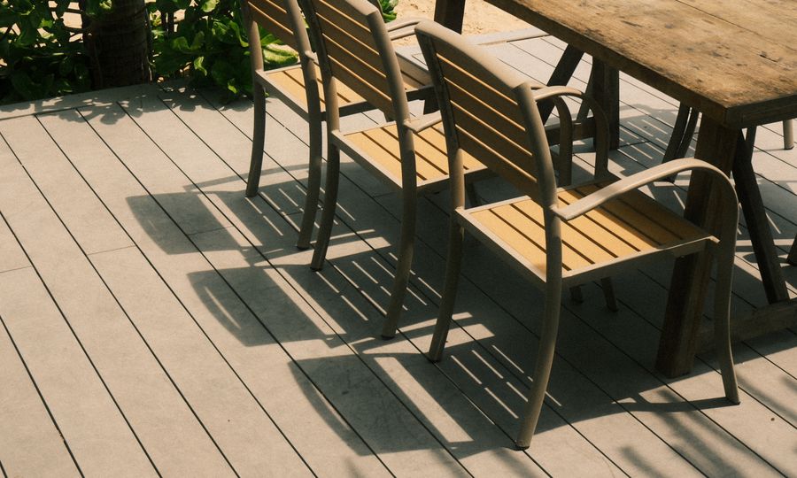 Outdoor patio furniture set with chairs and table in a garden setting