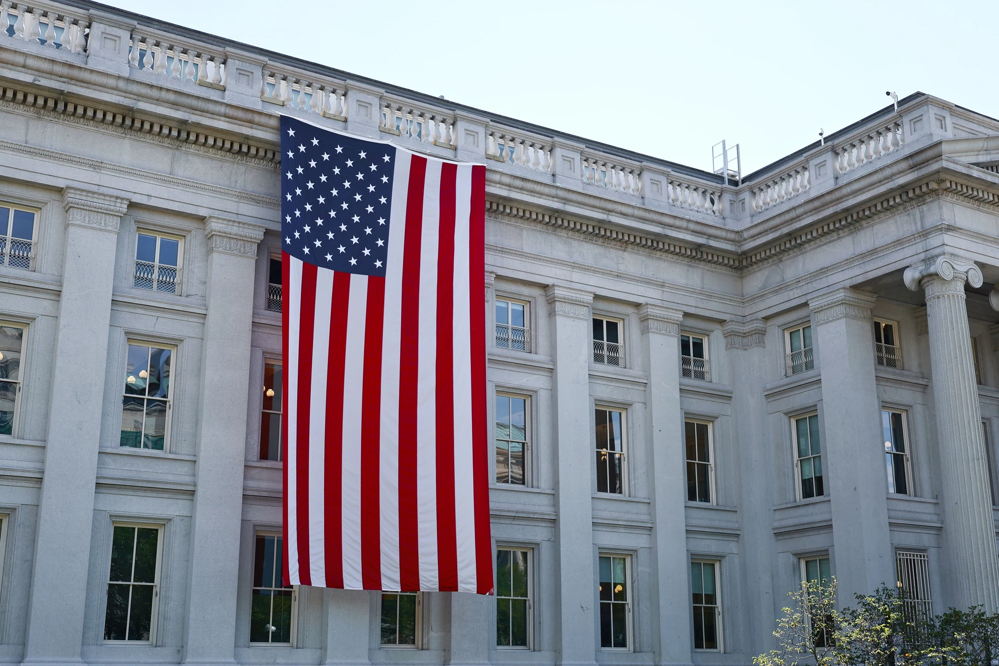 American flag on historic government building facade