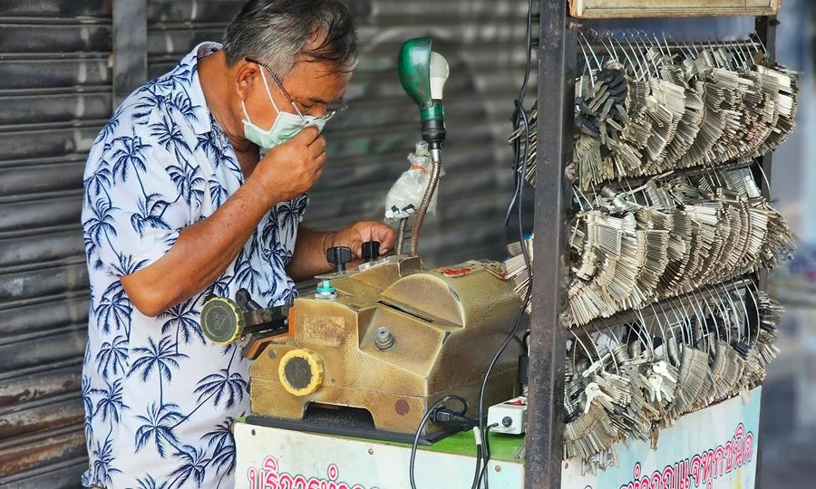 Professional locksmith working on door lock