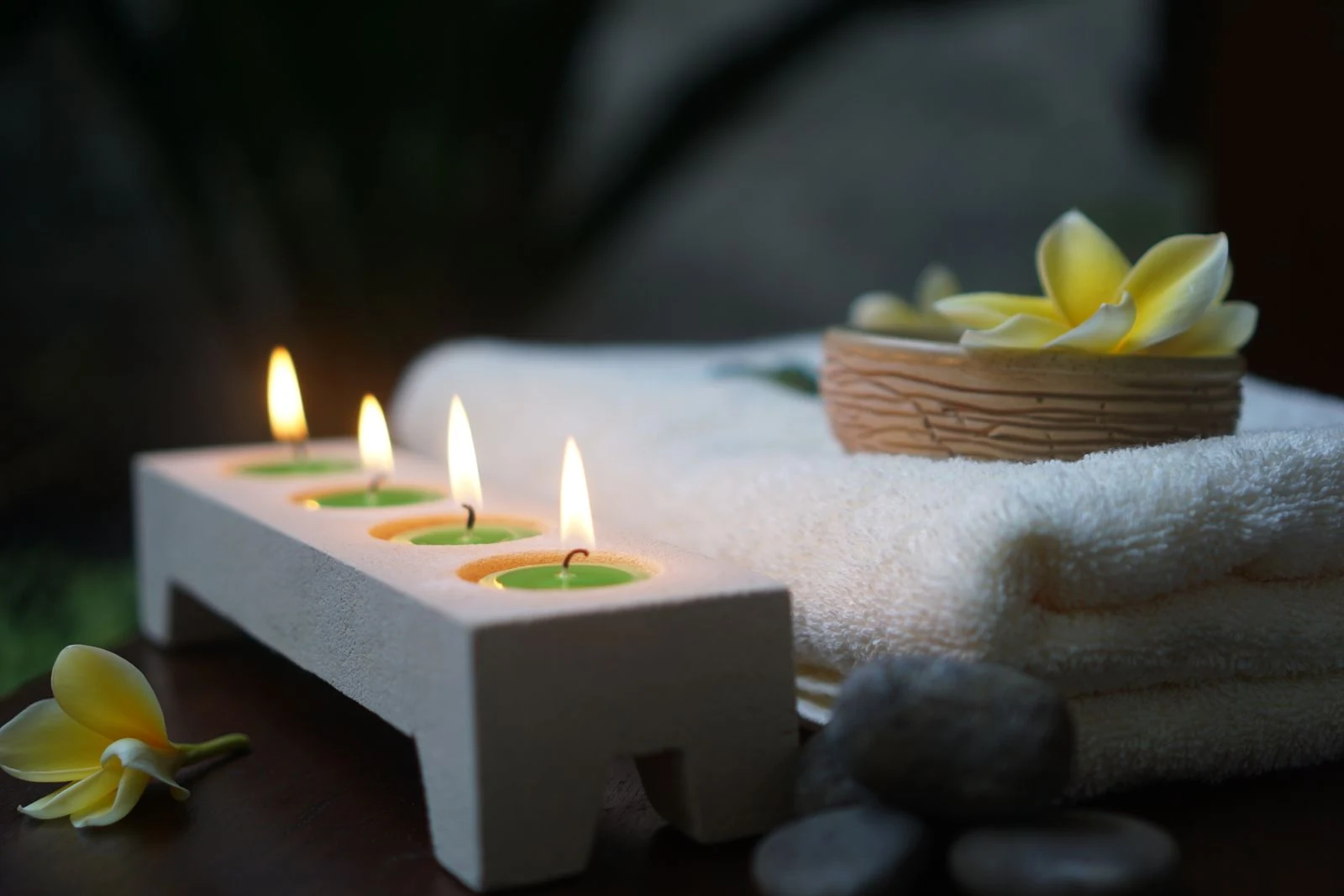 Calm spa setting with candles and natural stones